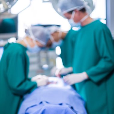 Surgeons performing operation in operation theater of hospital